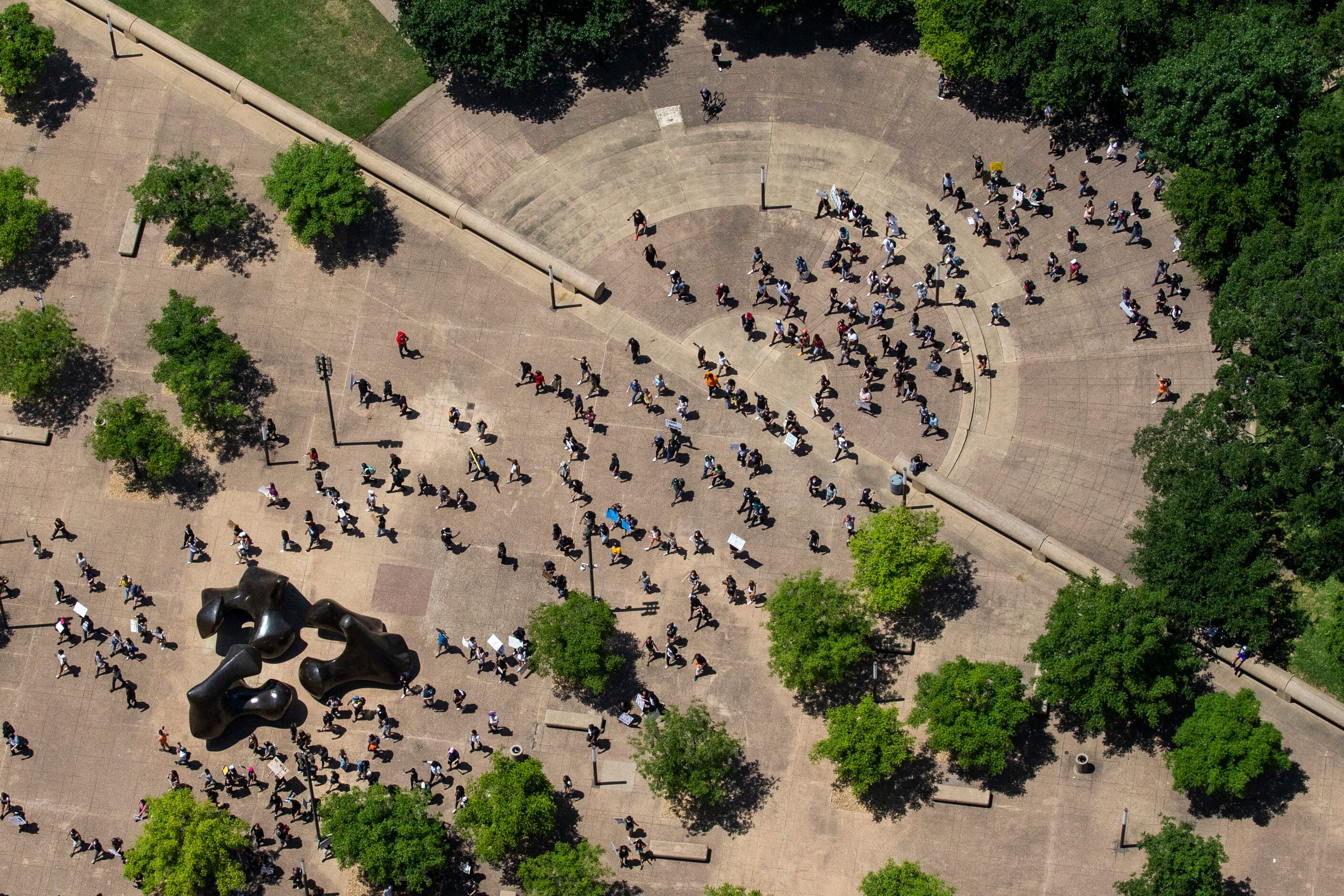 After marching throughout downtown Dallas, protesters march back to Dallas City Hall during...