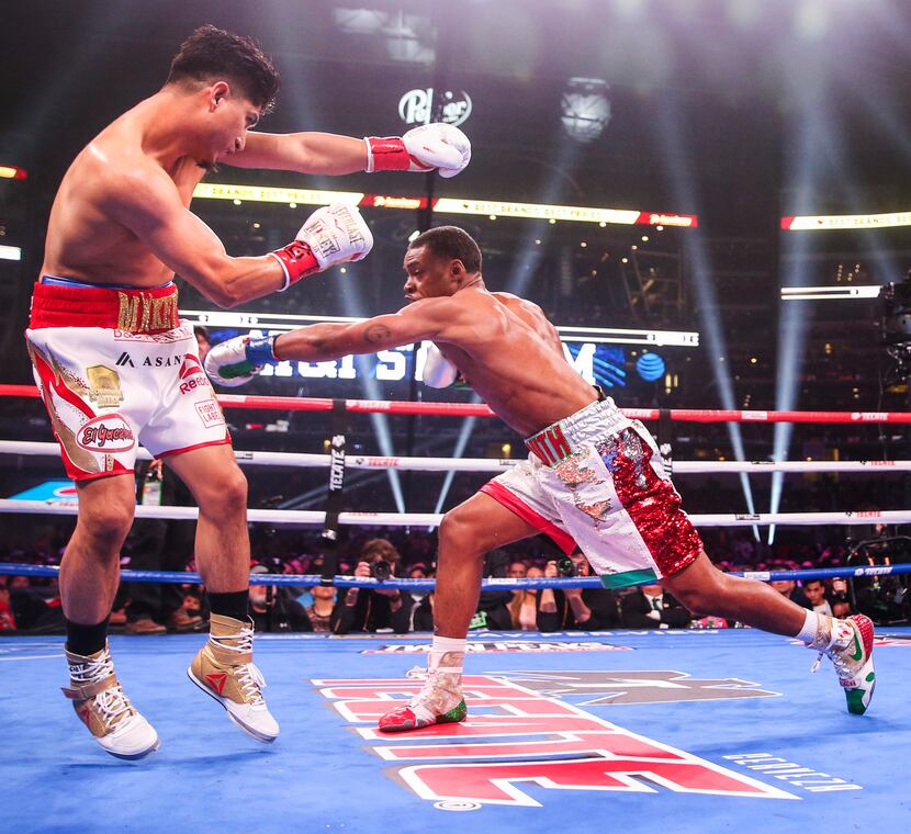 Mikey Garcia dodges a punch by Errol Spence Jr. during a IBF World Welterweight Championship...