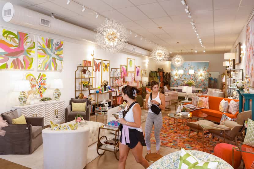 Nia Harrison (left) and Katherine Hall of Dallas check out the expanded section of Talulah &...