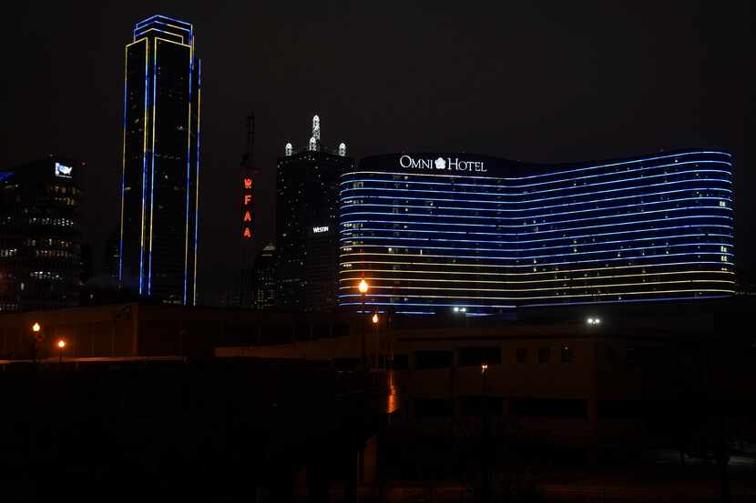 The Dallas Skyline is highlighted with Ukraine’s colors on Thursday, Feb. 24, 2022.