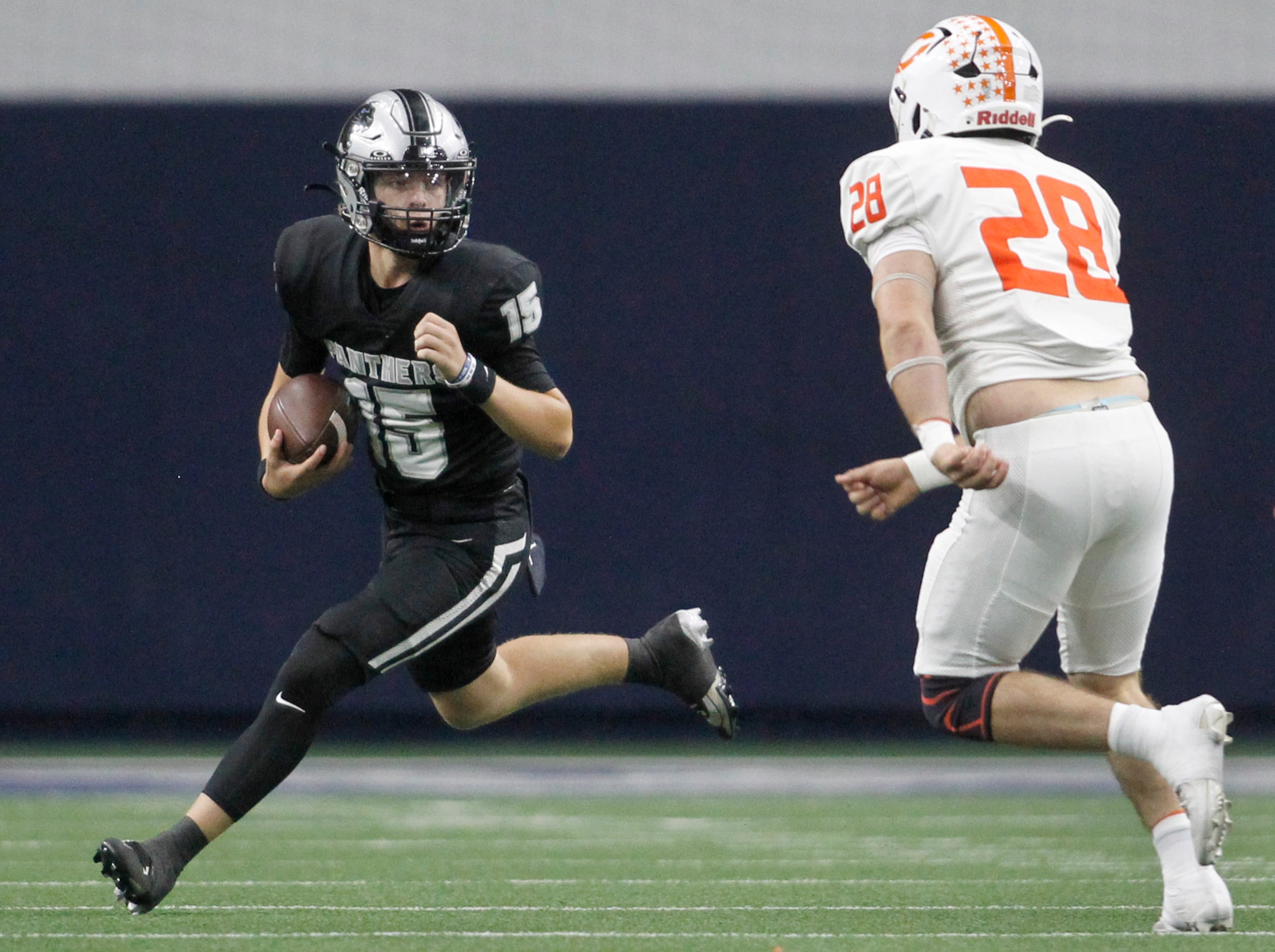 Frisco Panther Creek quarterback Graylyn Fry (15), left, looks for running room as he is...