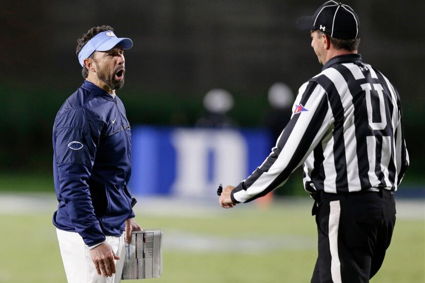 North Carolina head coach Larry Fedora argues with an official during the first half of an...