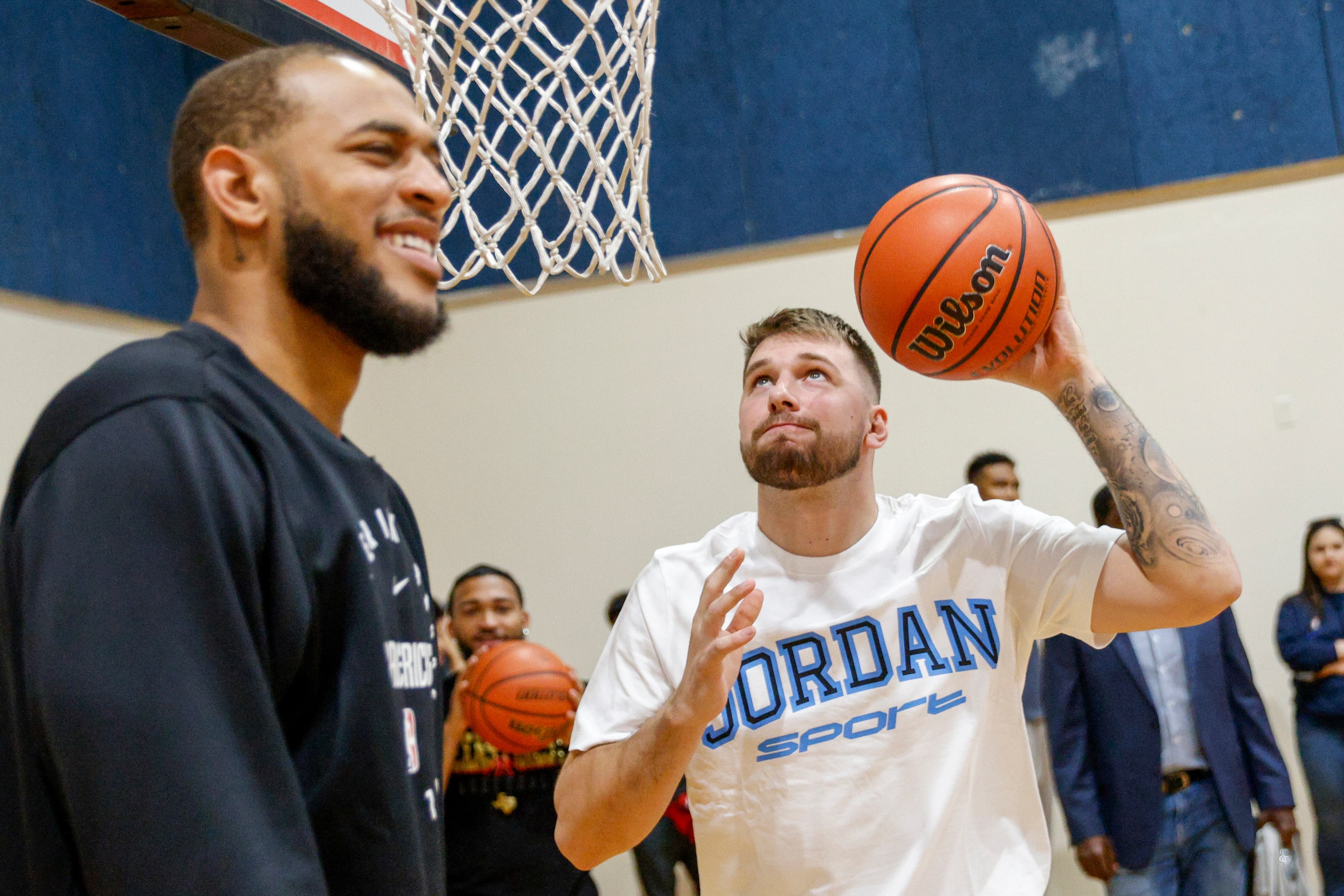 Dallas Mavericks guard Luka Doncic goes up for a dunk alongside center Daniel Gafford during...