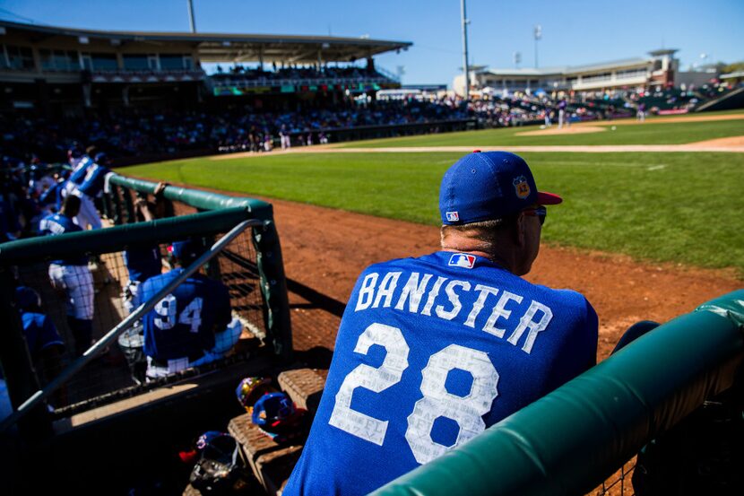 Texas Rangers manager Jeff Banister (28) watches from the dugout during the fifth inning of...