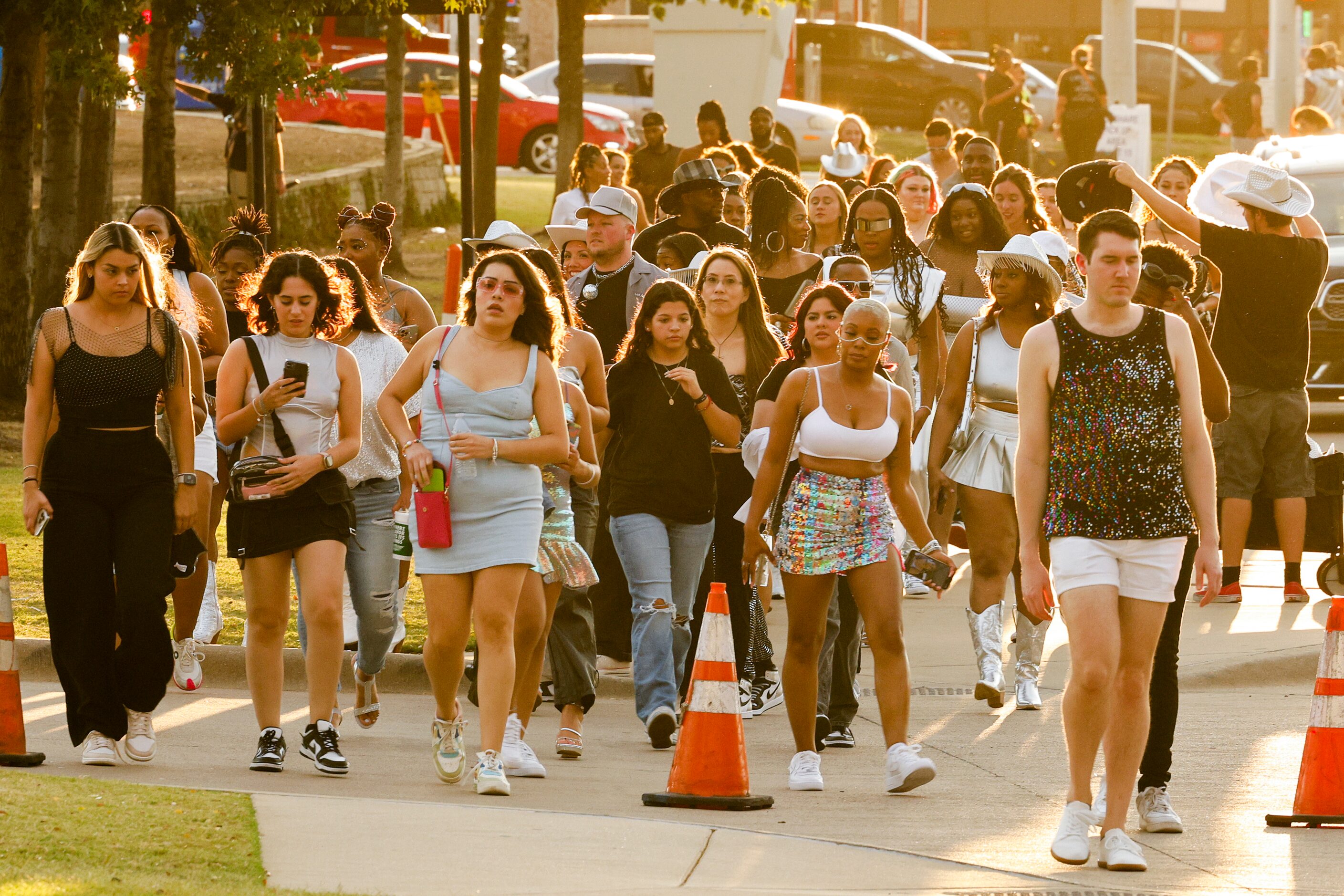 Concertgoers walk along Randol Mill Road before Beyoncé’s Renaissance World Tour concert at...