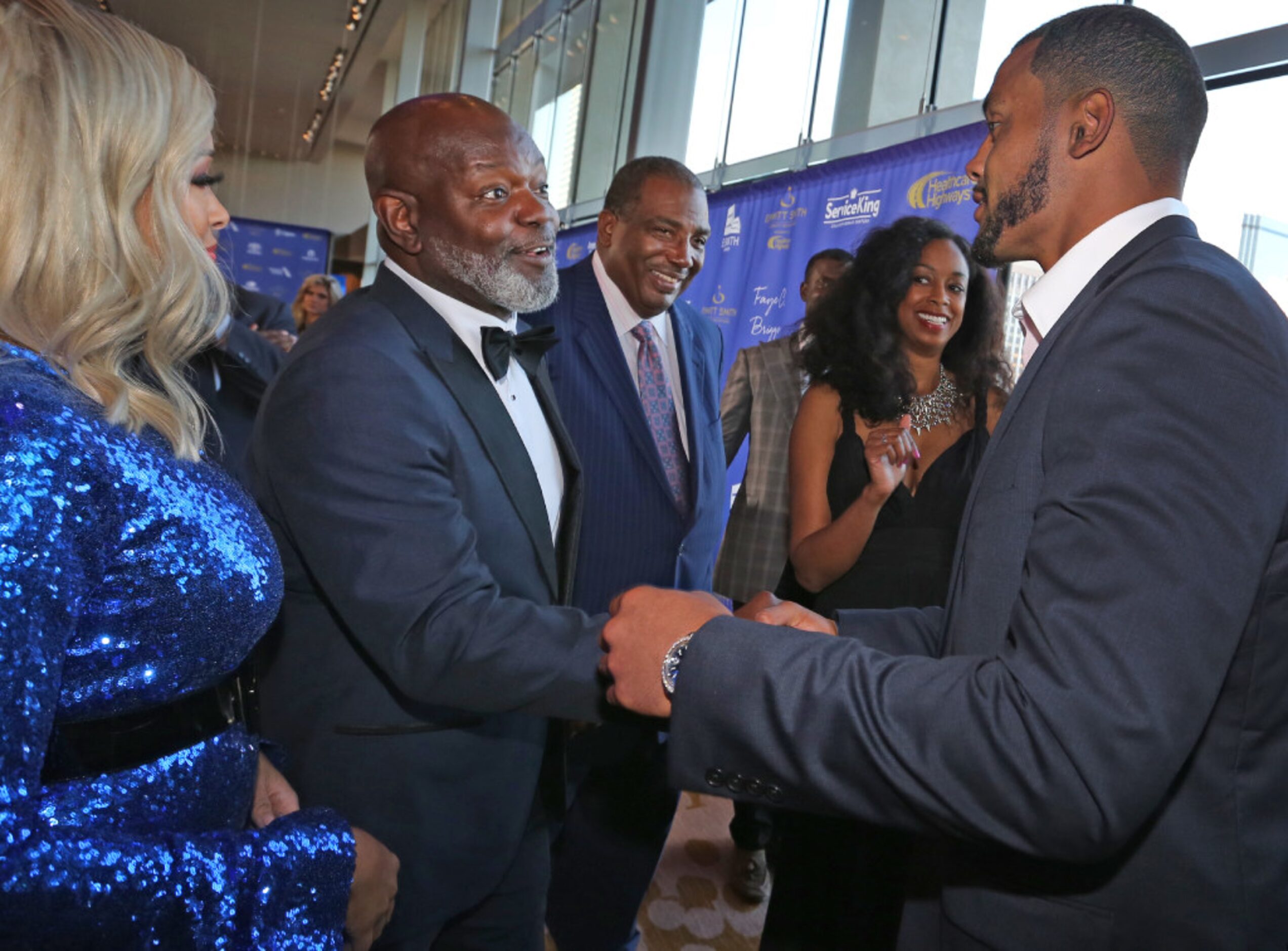 Dallas Cowboys legendary running back Emmitt Smith shakes hands with quarterback Dak...