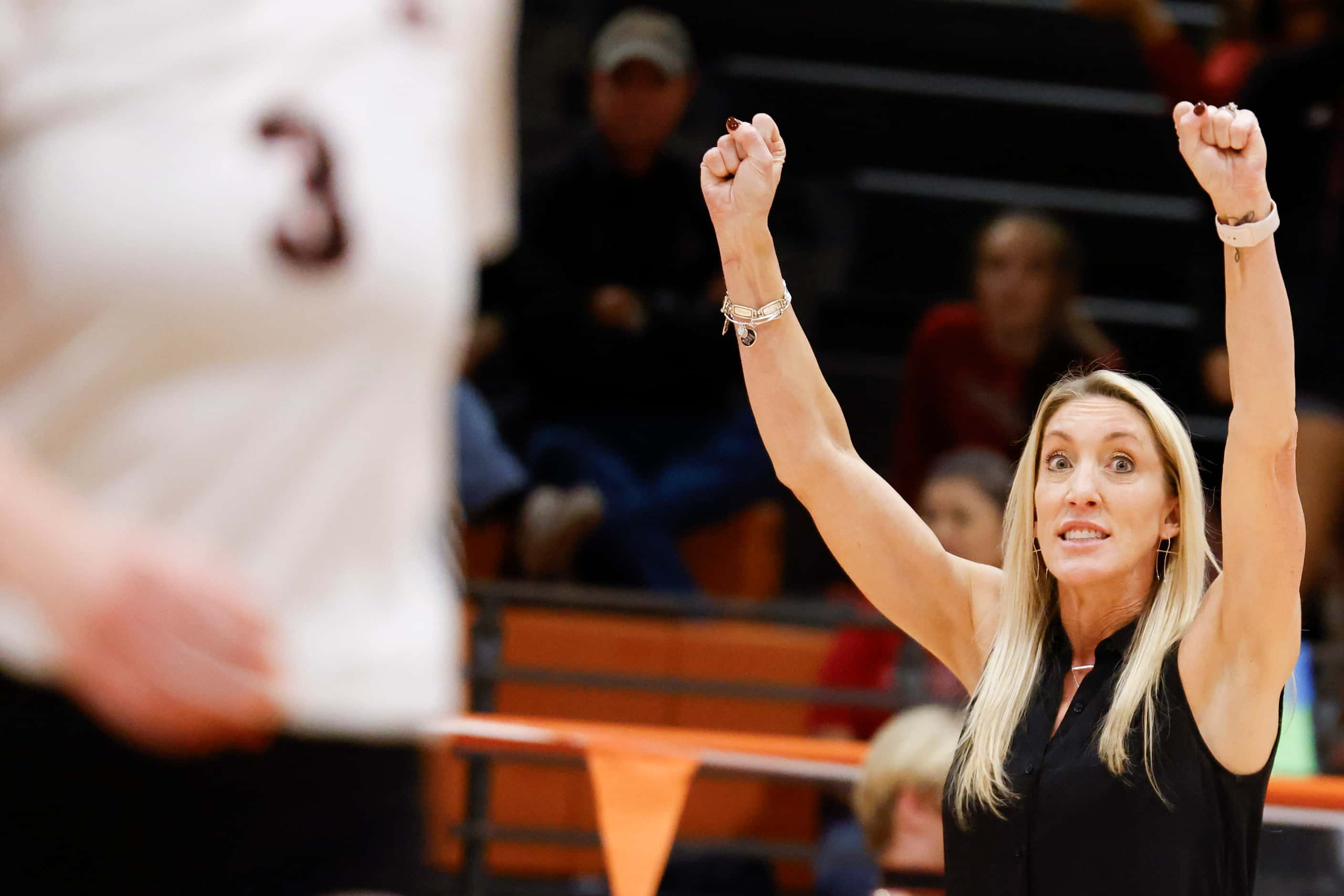 Rockwall Heath’s head coach Maggie Younger instructs the team during a volleyball game...