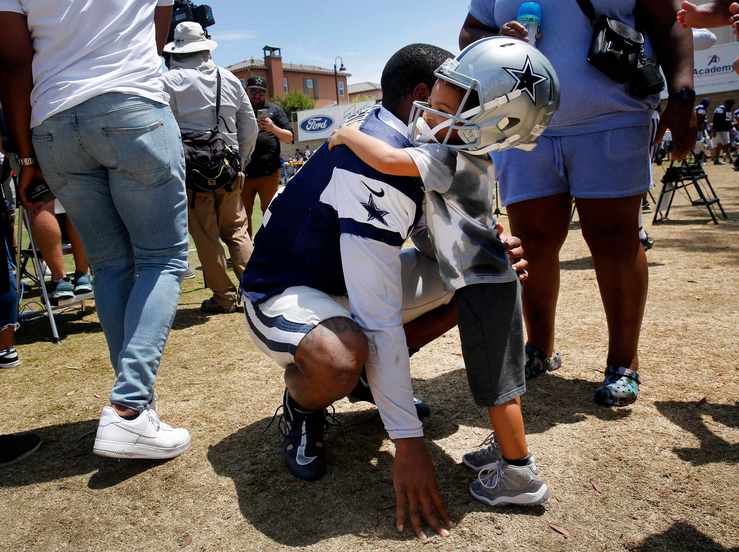 Dallas Cowboys outside linebacker Micah Parsons receives a hug from his son Malcolm...