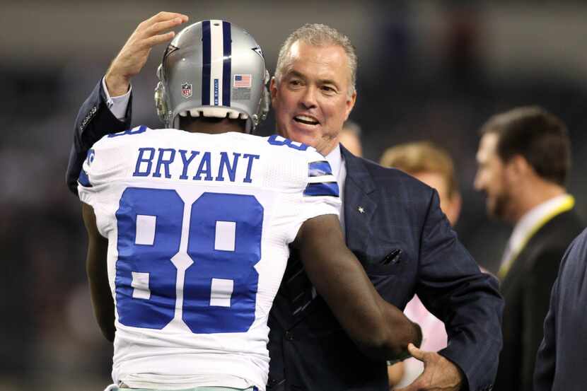 Dallas Cowboys wide receiver Dez Bryant (88) is hugged by vice president Stephen Jones while...