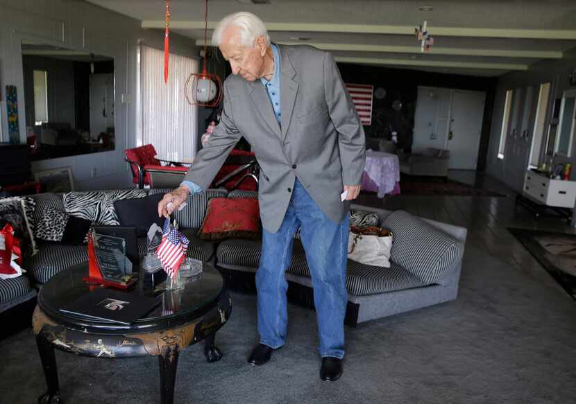 Rep. Ralph Hall adjusted miniature American flags on a coffee table at his home in Rockwall...