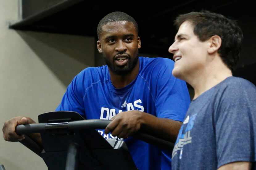 Dallas Mavericks Wesley Matthews talks with owner Mark Cuban at the end of practice at...