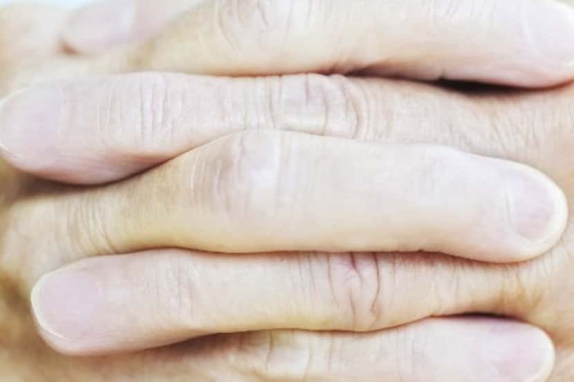 ORG XMIT:  Cropped Close-up of Woman's Clasped Fingers