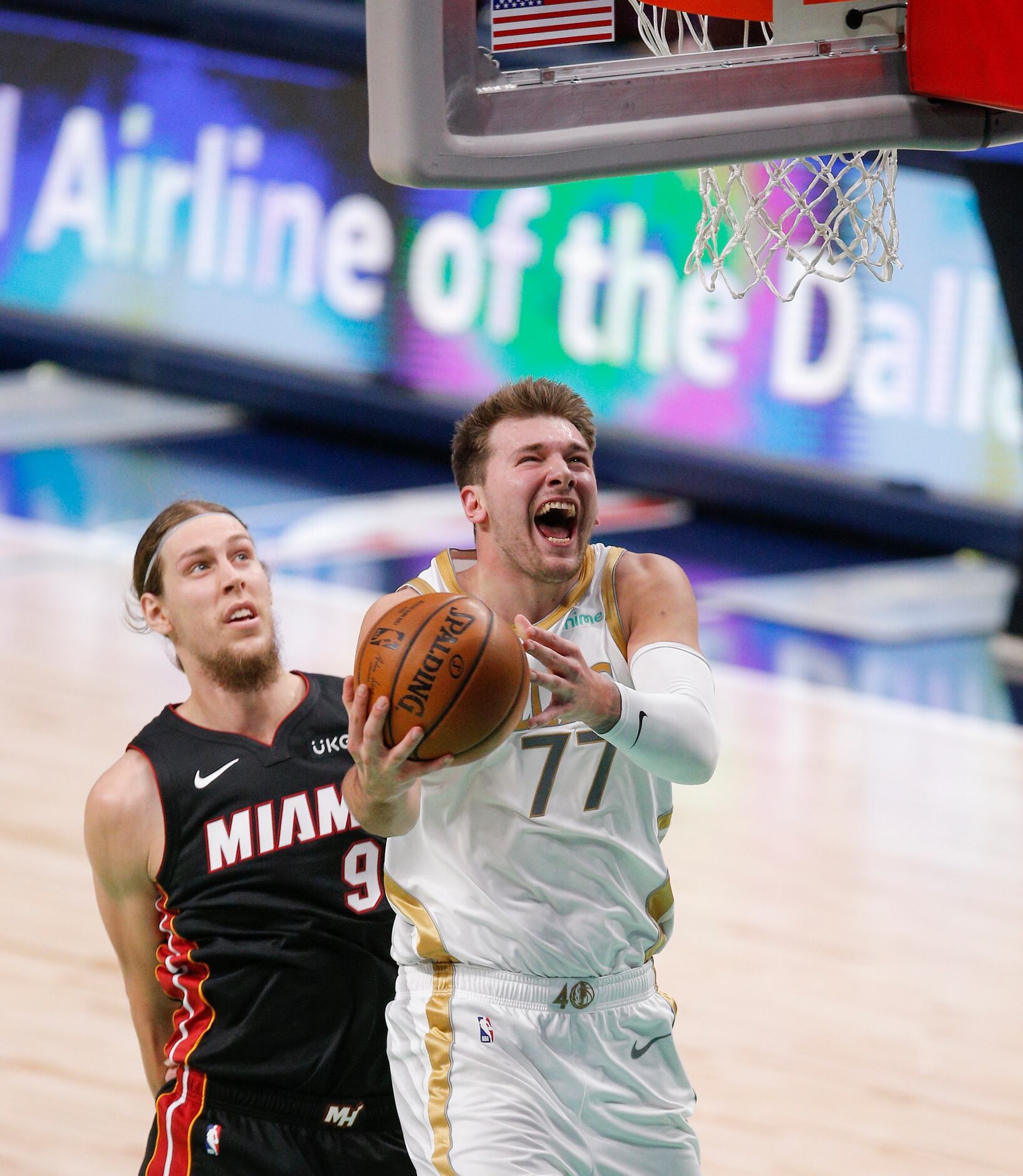 Dallas Mavericks guard Luka Doncic (77) attempts a shot as Miami Heat forward Kelly Olynyk...