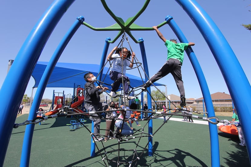 Children play on new playground equipment at Pearcy STEM Academy in Arlington ISD. The...