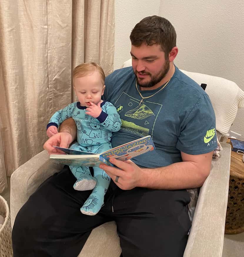 Cowboys offensive lineman Zack Martin reads a book to his son Charlie.