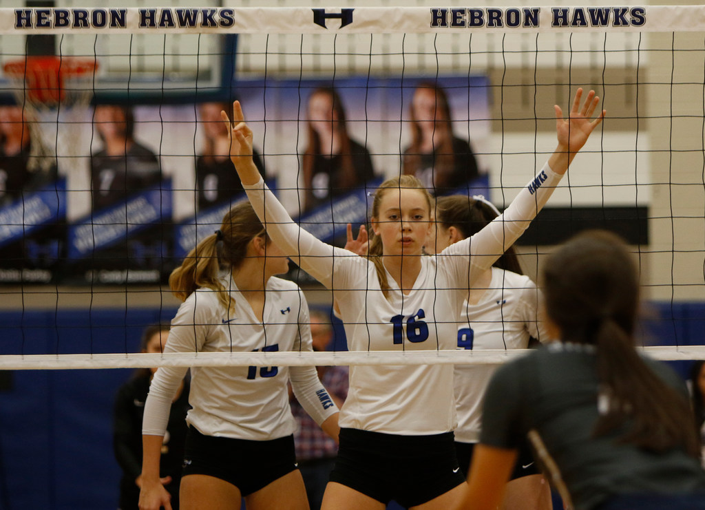 Hebron's Emma Clothier (16) prepares to defend the Hawks' turf during the opening set of...