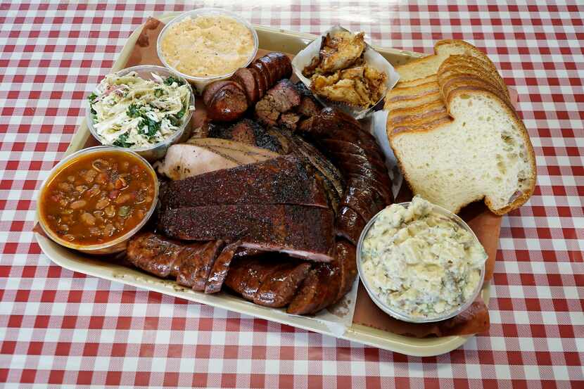 Platter with fatty brisket, jalapeño cheese sausage, turkey, ribs and sides at Goldee's...
