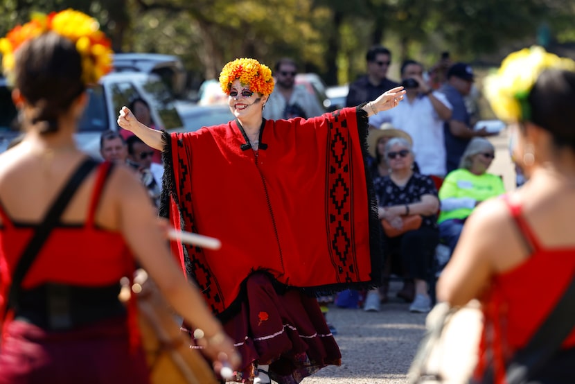 Lidia Lopez entertains the crowd while performing a folkloric piece during Day of the Dead...