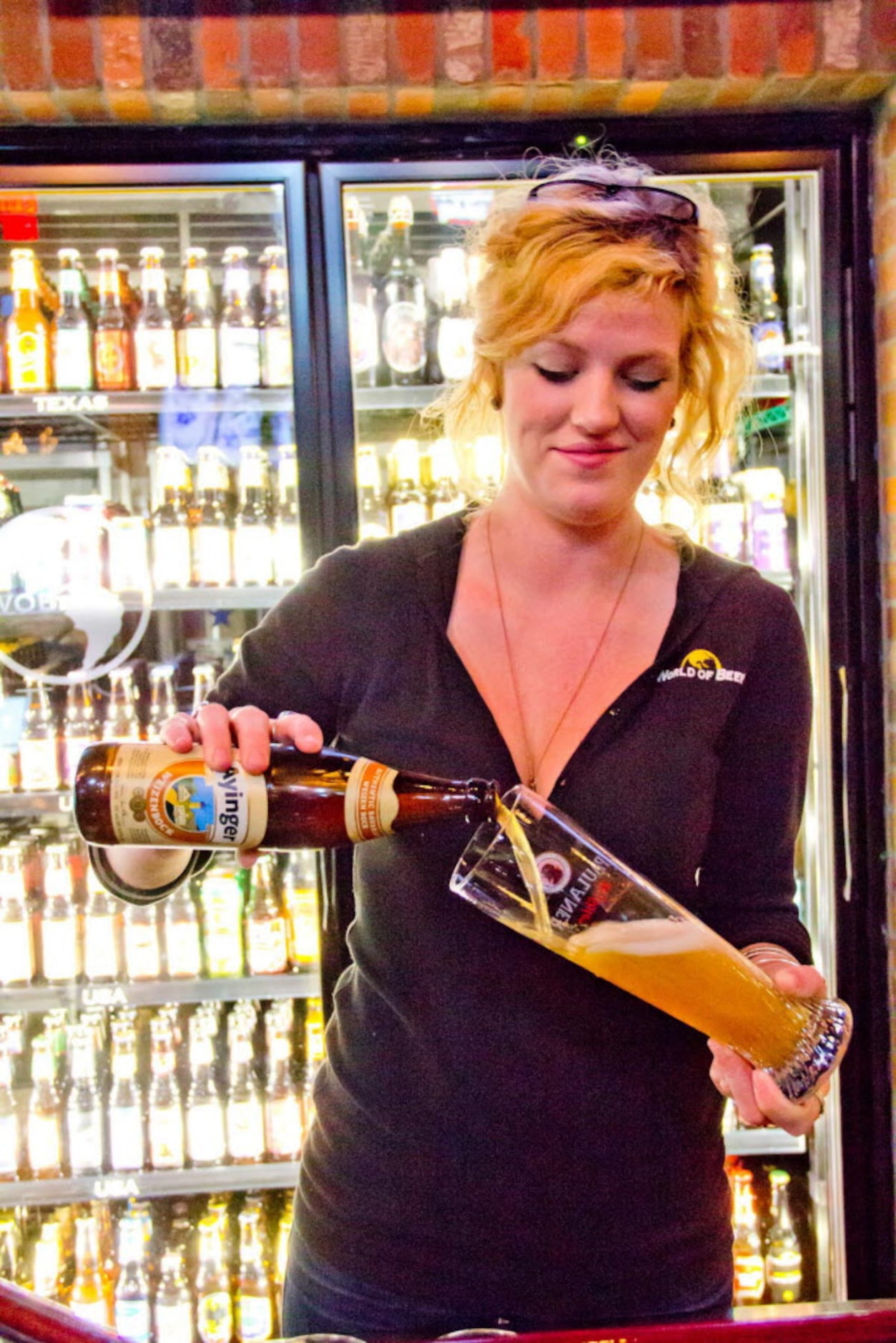 Bartender Jen Durham at World of Beer serves up an imported beer from Germany on Dec 30,...