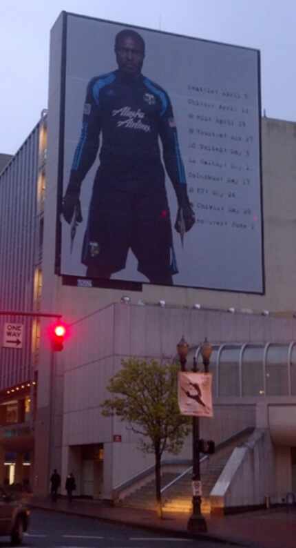 A building size banner in downtown Portland advertising the Timbers schedule.