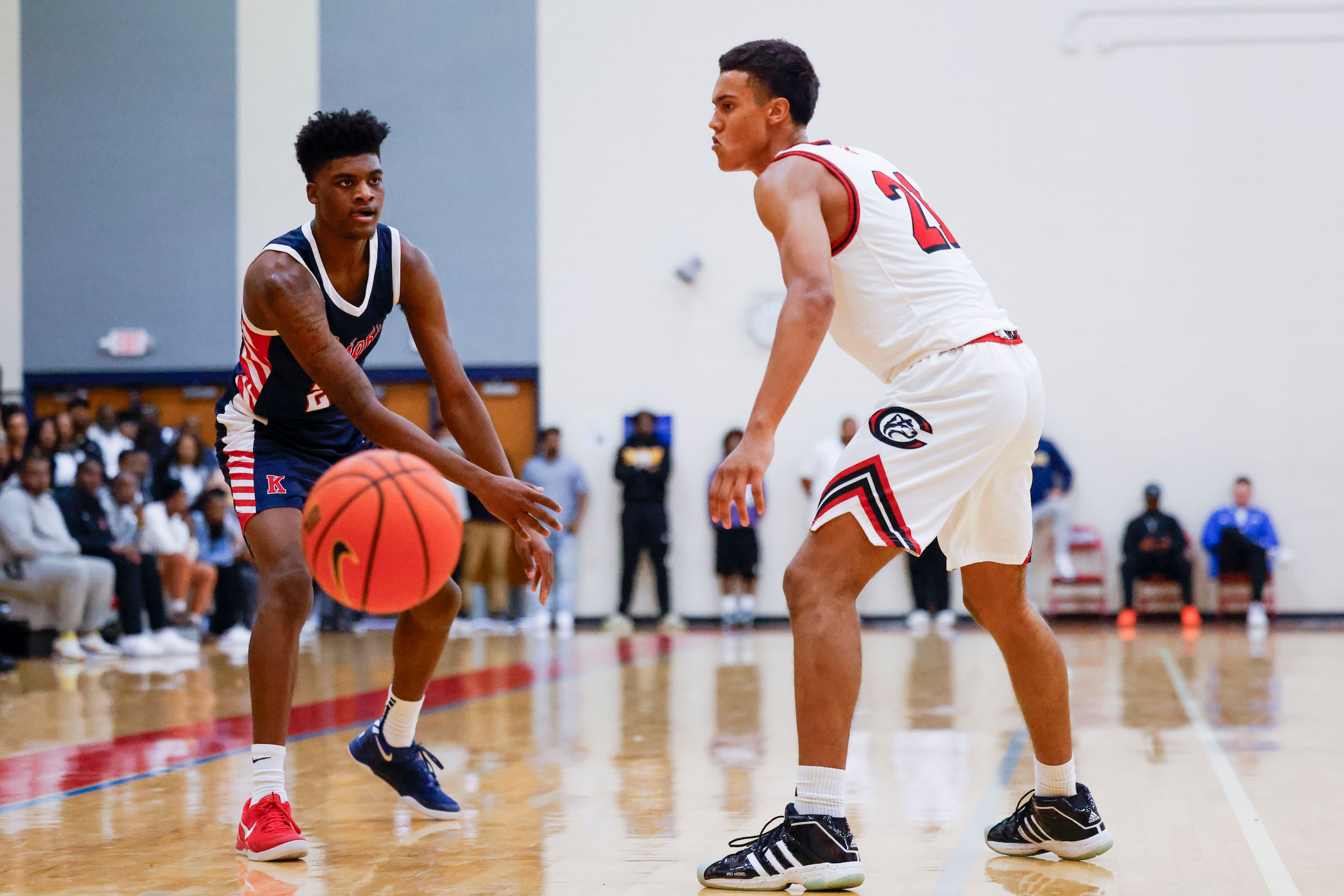 Kimball High’s Jaylin Hancock (left) passes the ball past Centennial High’s Isaiah Rogers...