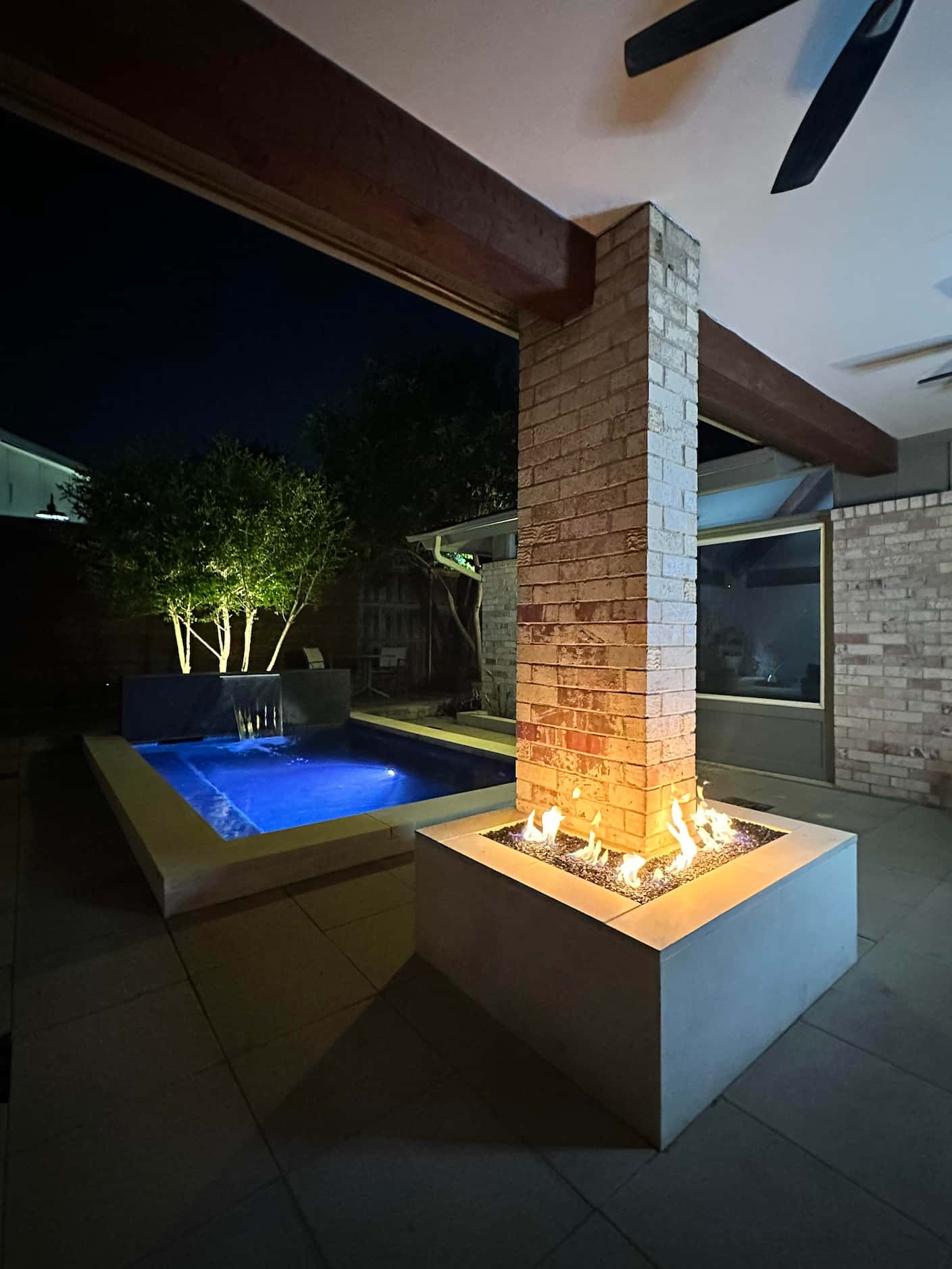Cocktail pool at night with fire pit