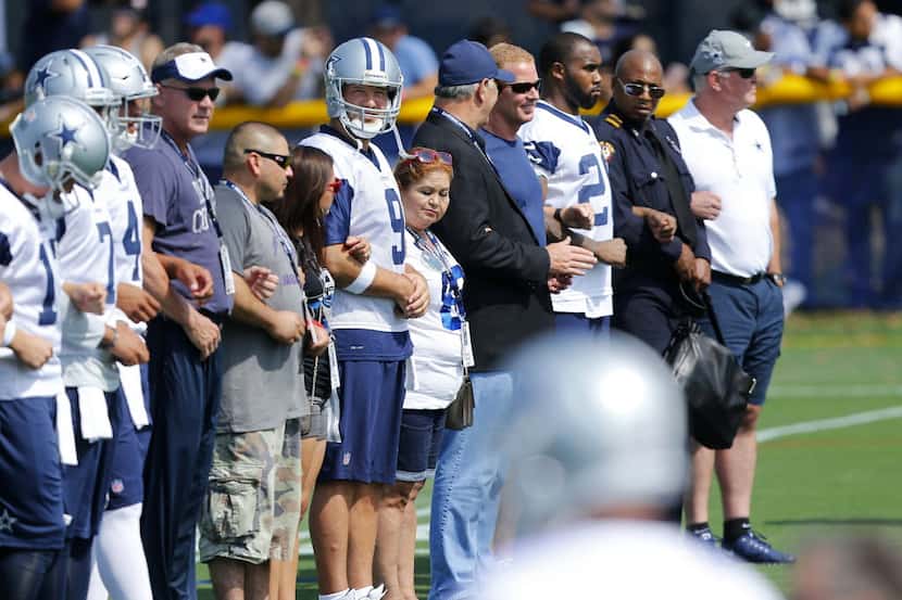 Dallas Cowboys quarterback Tony Romo (9) joined the family of slain officer Patrick...