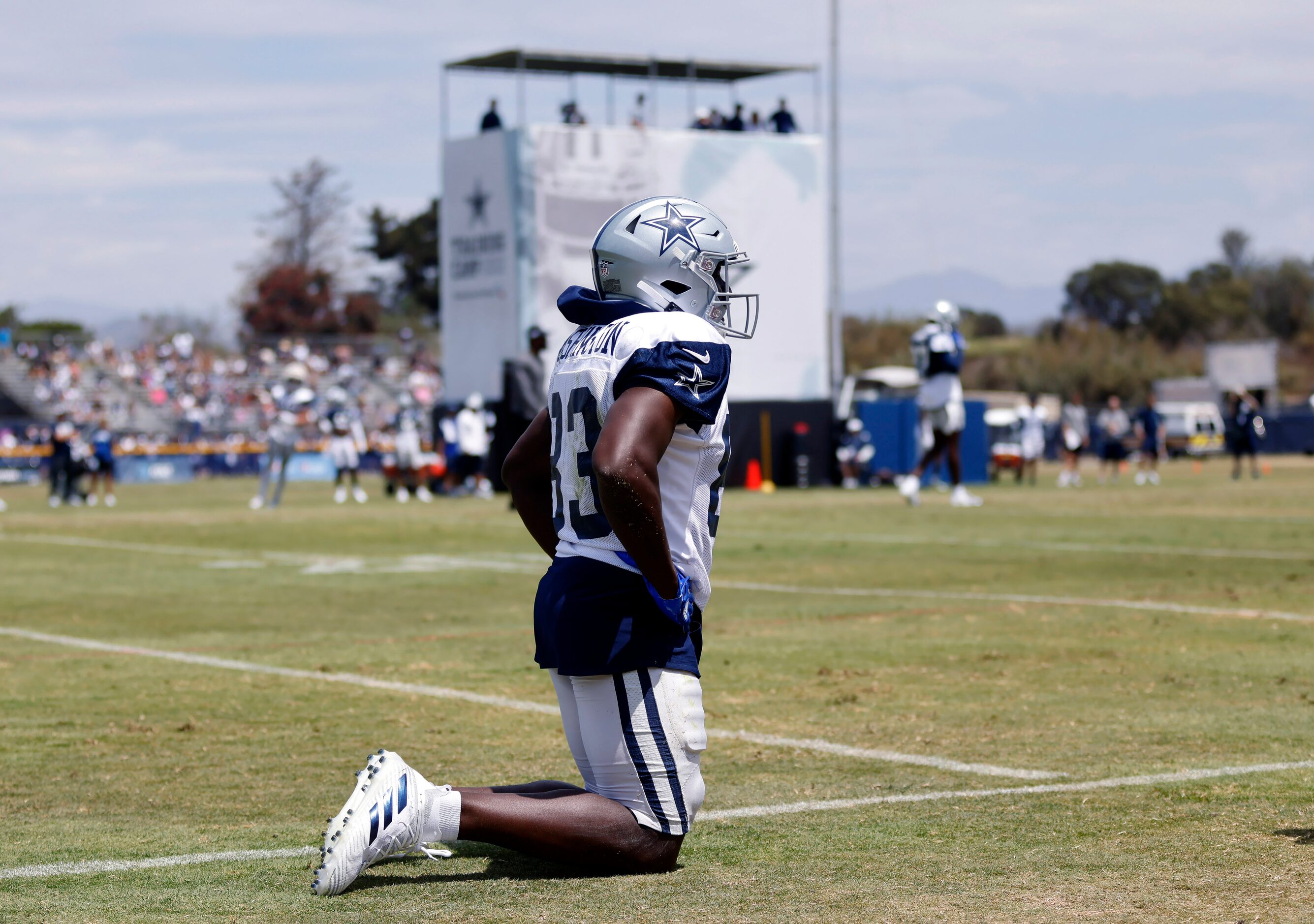 Dallas Cowboys wide receiver James Washington (83) is slow to get up after racing down the...