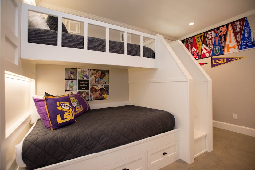 An extra-long railing on the top bunk of this set of bed provides security for young...
