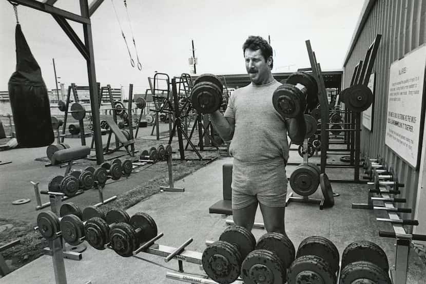 Cowboys defensive lineman Randy White lifts weights at the team's practice facilities at...