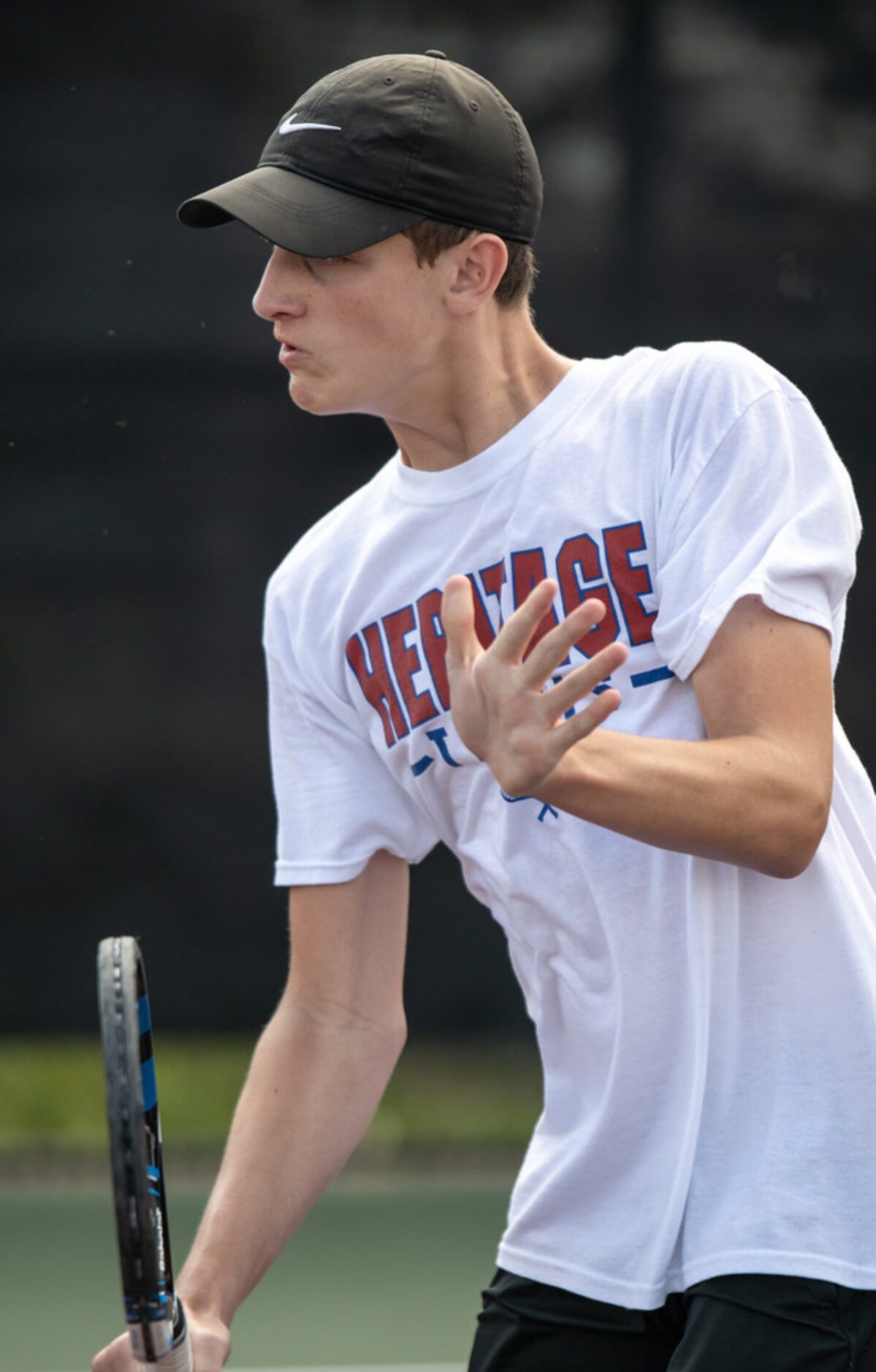 Midlothian Heritage's Gabe Bell returns the ball in a doubles match with teammate Joshua...