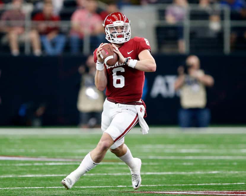 FILE - Oklahoma quarterback Baker Mayfield (6) rolls out to pass during the second quarter...