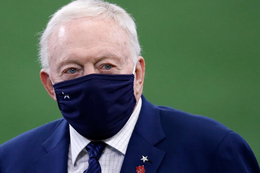 Cowboys owner and general manager Jerry Jones walks the field during warmups before a game...