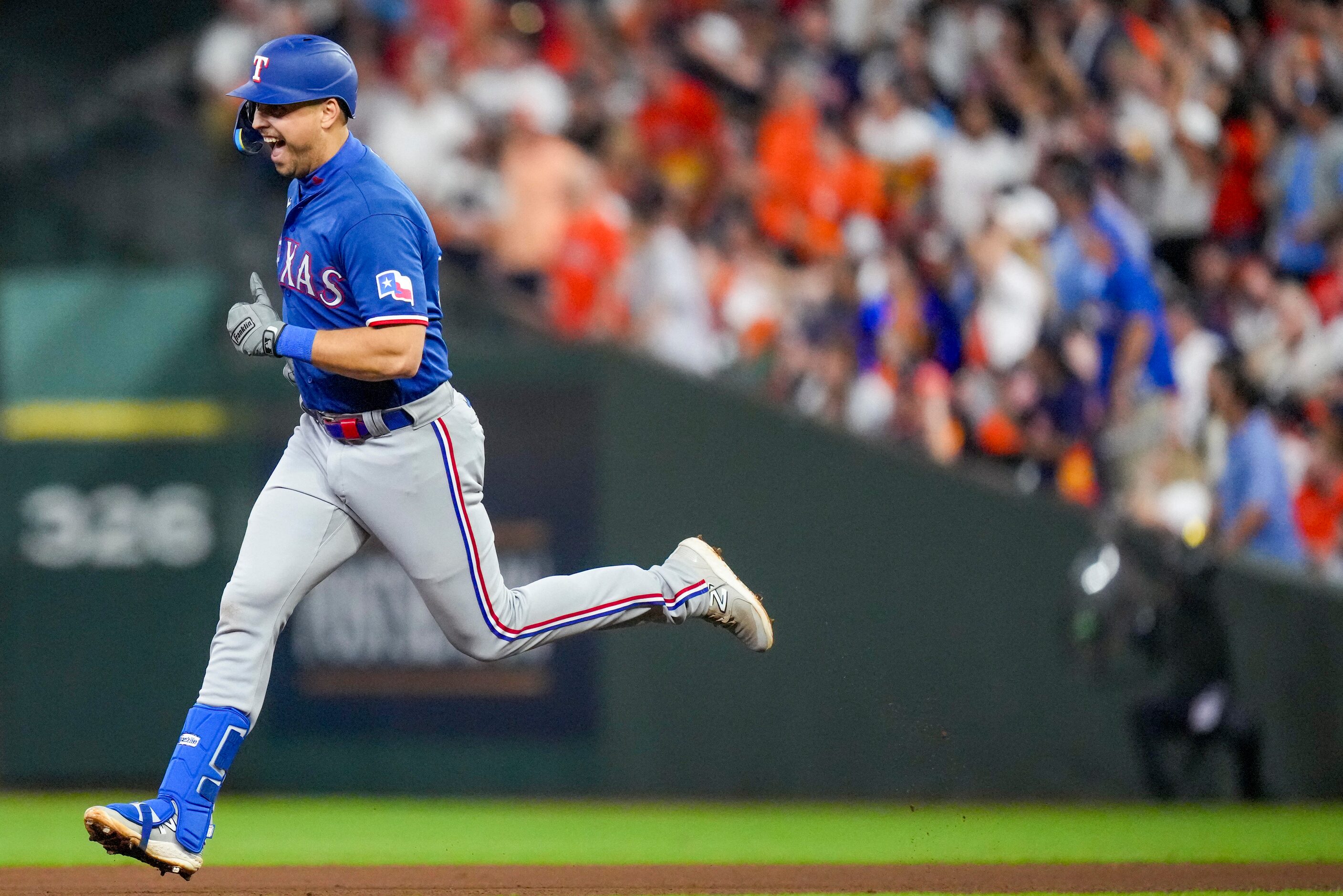 Texas Rangers first baseman Nathaniel Lowe rounds the bases after hitting a two run home run...