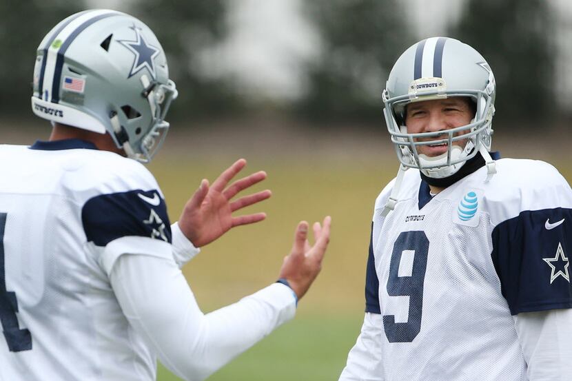 Dallas Cowboys quarterback Tony Romo (9) and quarterback Dak Prescott (4) speak in-between...