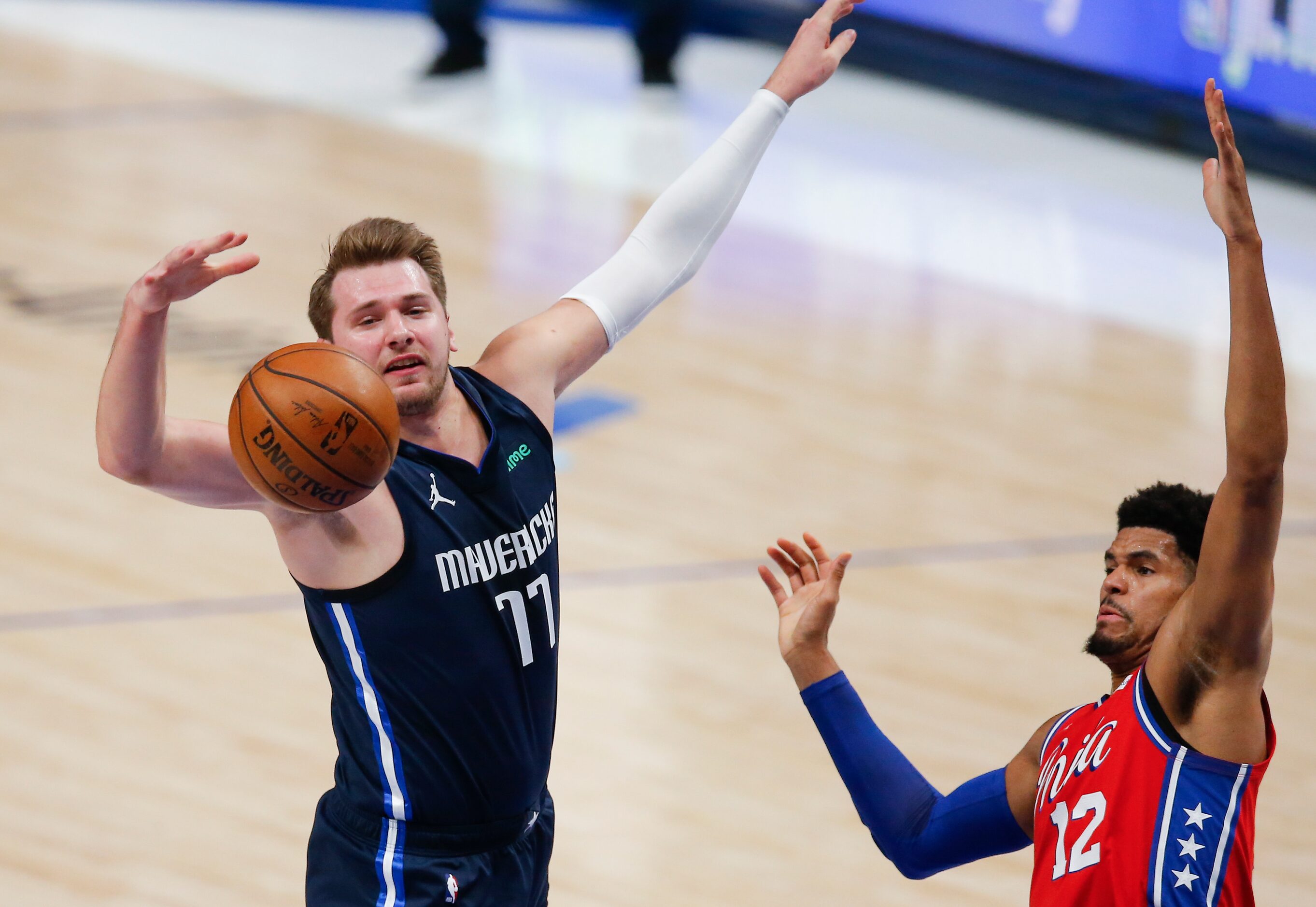 Dallas Mavericks guard Luka Doncic (77) and Philadelphia 76ers forward Tobias Harris (12)...