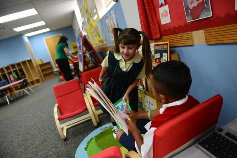 
Kindergarteners Jagan Thomas (right) and Jacqueline Michael read books on the first day of...