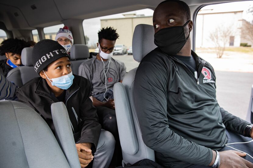 Dallas Christian College's coach Dwight Coleman (right) turns to speak to his team while...