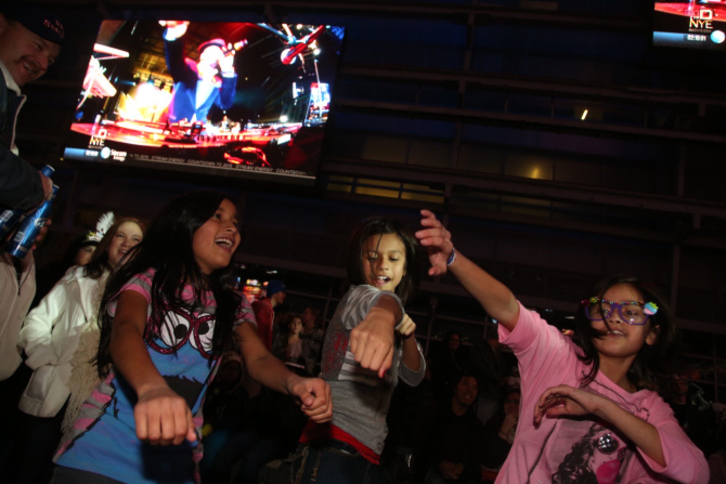 From left, Jazmine Davila, 10, Lauren Campos, 9, and Brianna Salazar dance during Big D New...