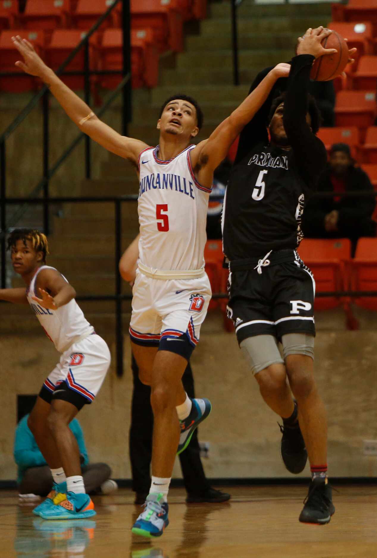 Duncanville guard Micah Peavy (5) leaps to knock the ball away from Odessa Permian forward...