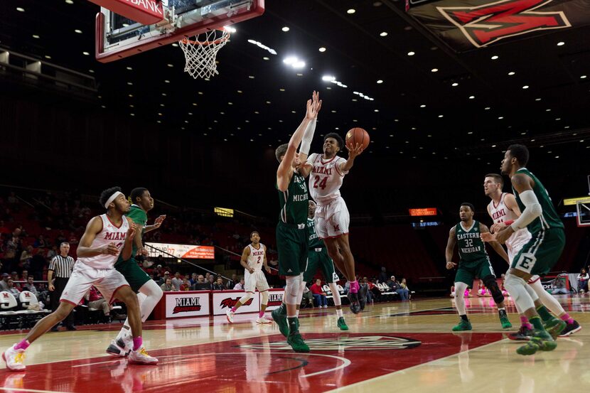 Michael Weathers (24) goes up for a shot as Marcus Weathers (22) looks to position himself...