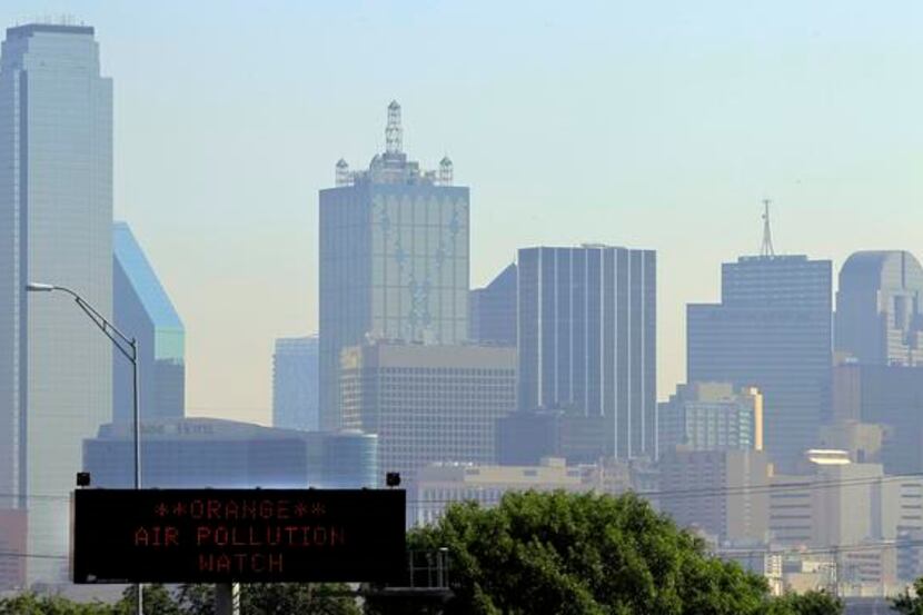 
A sign alerts drivers on Interstate 35E to pollution conditions on a summer day in Dallas....