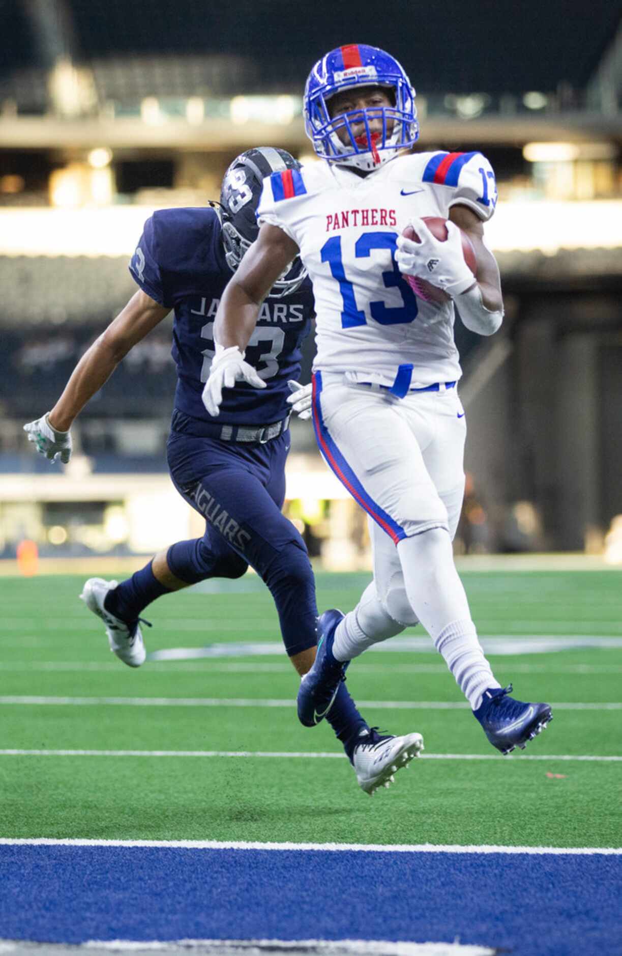Duncanville wide receiver Roderick Daniels leaps into the endzone to score a touchdown...