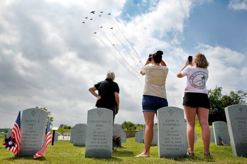 Three generations of the Wolniewicz family watched a group of old warplanes perform a...