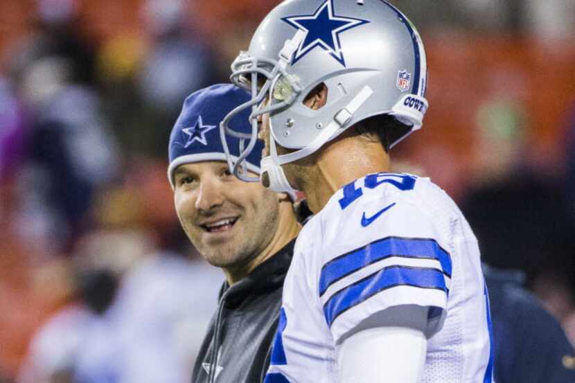 Injured Dallas Cowboys quarterback Tony Romo (9) talks to Dallas Cowboys quarterback Matt...