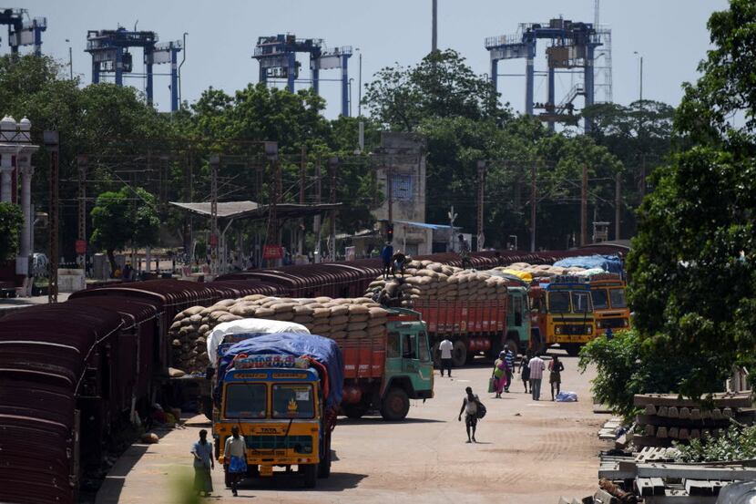 An Indian labourer loads grain sakcs on to a truck at a railway goods yard in Chennai on...