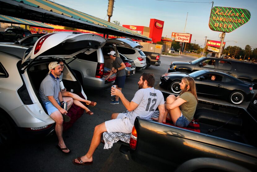 Japhen Lott and his wife Miranda (left) tailgate with friends Jon Gohn and his wife Lauren...