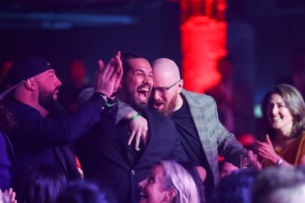 Julian Shaffer (center), bar manager at Rye in Dallas, reacts after winning the Exceptional...