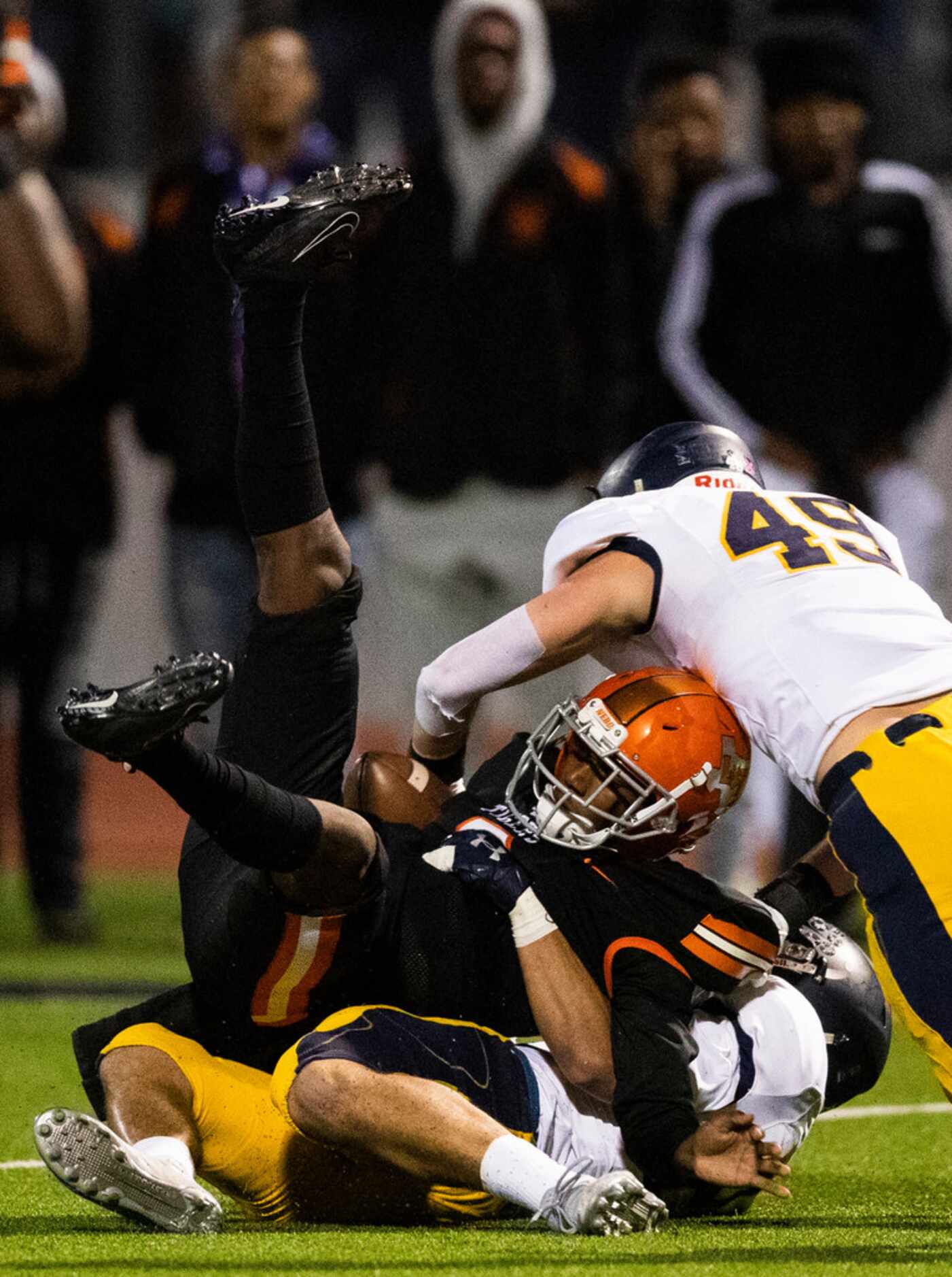 Lancaster quarterback Glenn Rice Jr. (3) is tackled by Highland Park defensive backs John...