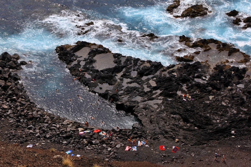 At the natural tidal pool at Ponta da Ferraria, a hot spring blends with ocean water at low...